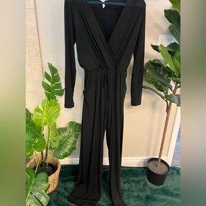 Classic black pantsuit with deep v-neck, pockets, cutout back and tie waist